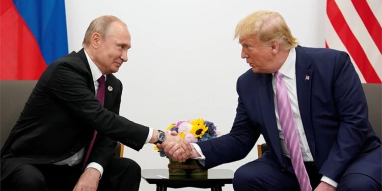 File Photo: Putin Shakes  Hand with Trump